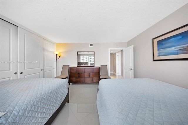 bedroom with visible vents and a closet