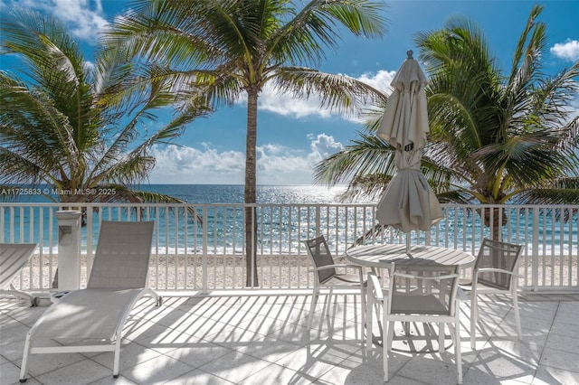 view of patio featuring a water view and a view of the beach