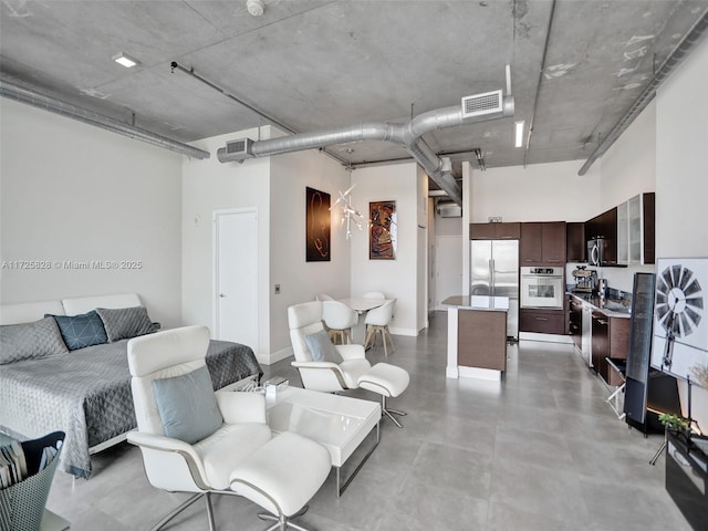 living room featuring a high ceiling