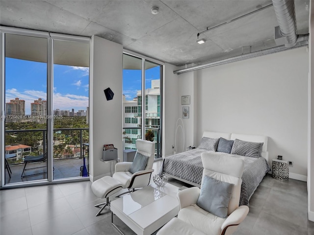 bedroom with access to exterior, multiple windows, and floor to ceiling windows