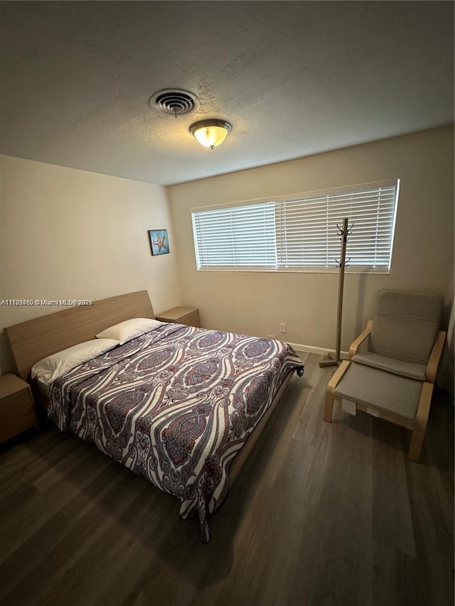 bedroom featuring dark hardwood / wood-style flooring