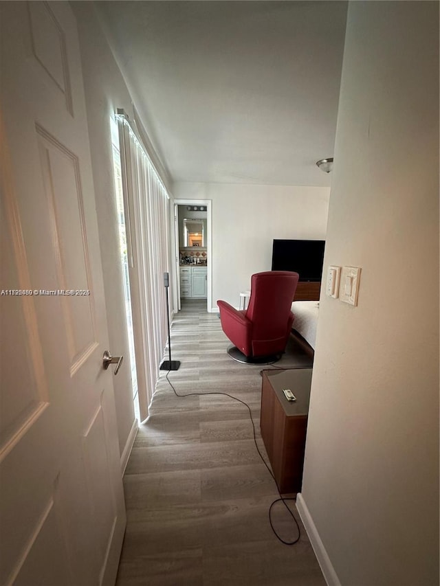 corridor with light hardwood / wood-style floors