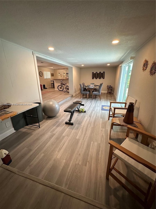 workout room featuring a textured ceiling and hardwood / wood-style floors