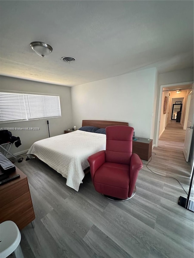 bedroom with wood-type flooring