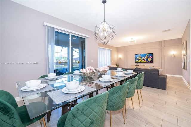 dining space with an inviting chandelier