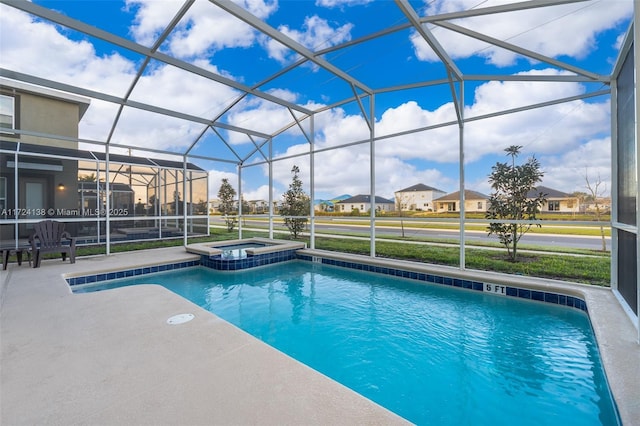 view of swimming pool with a lanai, a patio, and an in ground hot tub