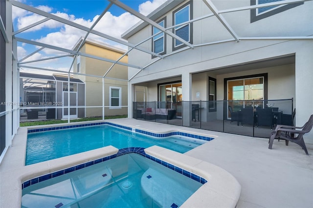 view of pool featuring a lanai, an in ground hot tub, and a patio area