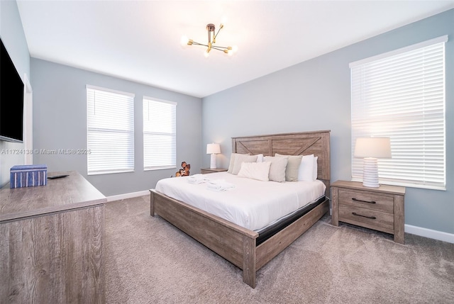 bedroom featuring a notable chandelier and carpet