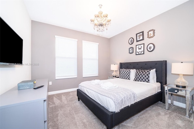 bedroom with carpet flooring and an inviting chandelier