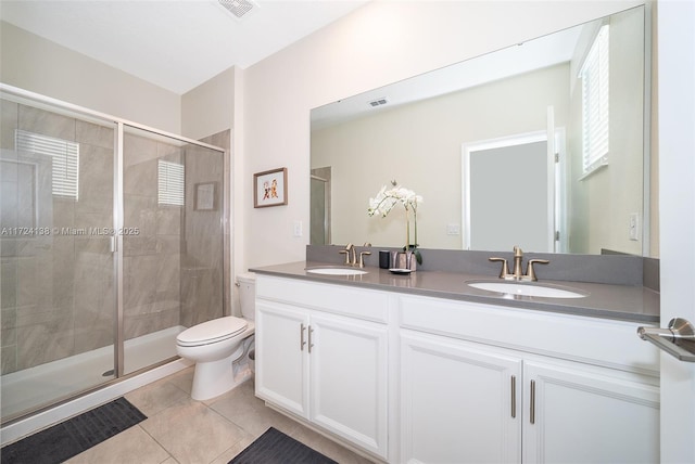 bathroom with toilet, an enclosed shower, tile patterned flooring, and vanity