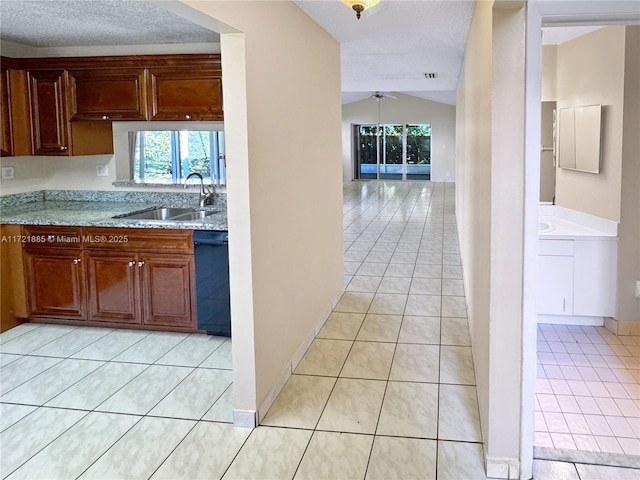 kitchen with sink, vaulted ceiling, black dishwasher, ceiling fan, and light tile patterned floors