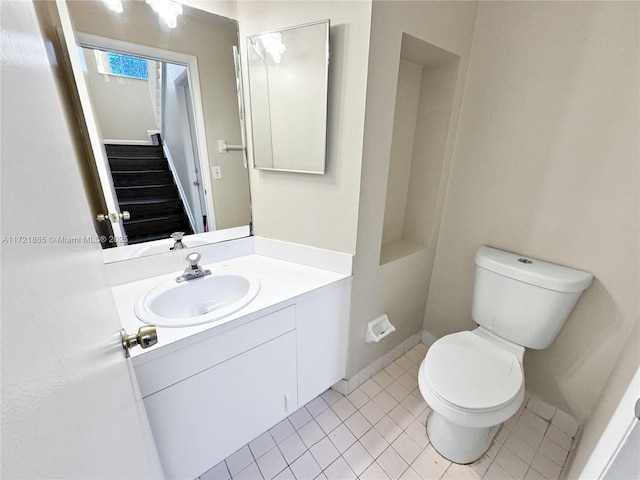 bathroom featuring tile patterned flooring, vanity, and toilet