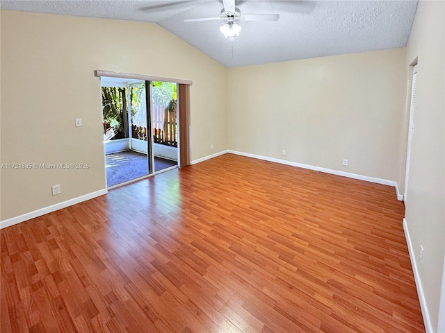 spare room featuring a textured ceiling, ceiling fan, vaulted ceiling, and light hardwood / wood-style flooring