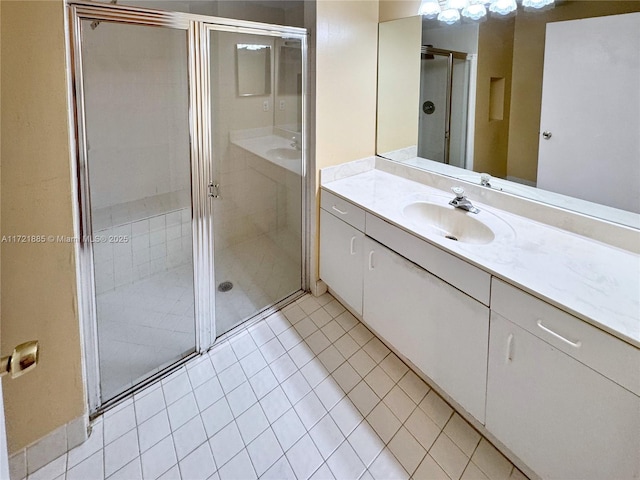 bathroom with tile patterned flooring, an enclosed shower, and vanity