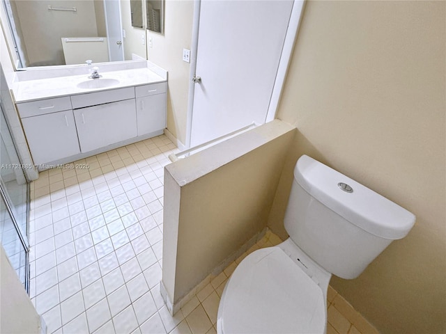 bathroom featuring toilet, tile patterned flooring, and vanity