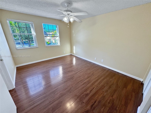 unfurnished room featuring a textured ceiling, ceiling fan, and dark hardwood / wood-style floors