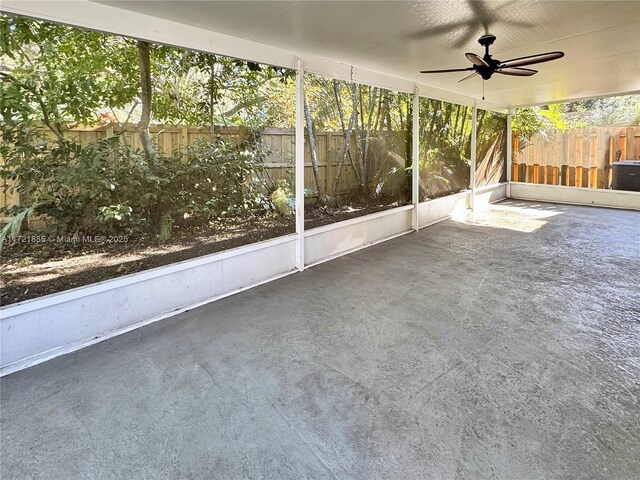 unfurnished sunroom with ceiling fan