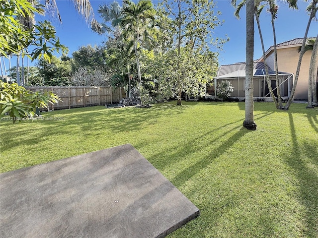 view of yard with glass enclosure