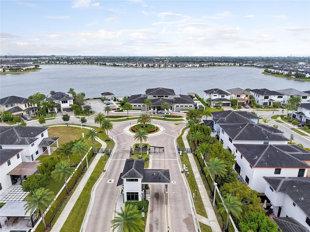 drone / aerial view with a water view and a residential view