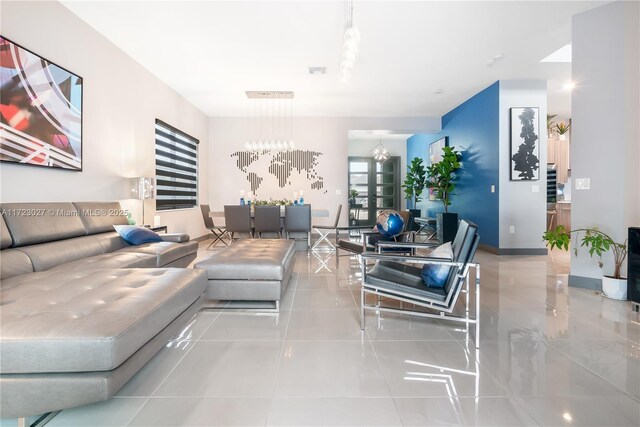 tiled living area with visible vents and an inviting chandelier