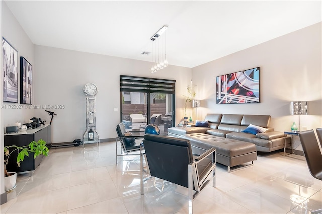 living area featuring visible vents, baseboards, and light tile patterned flooring
