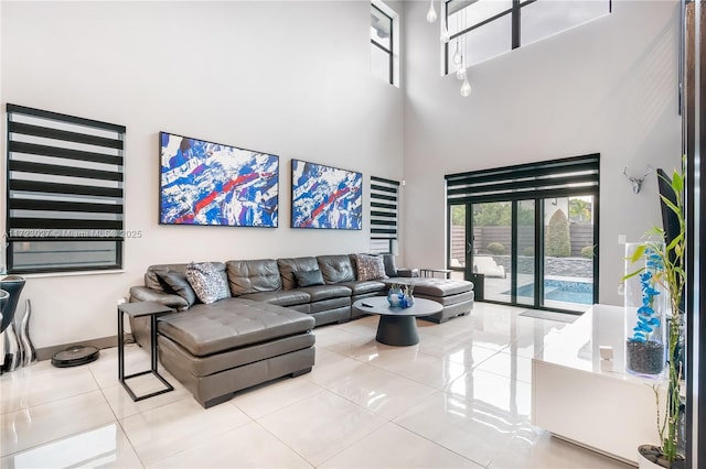 tiled living area featuring a high ceiling