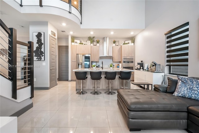 living area with recessed lighting, stairs, a high ceiling, and light tile patterned flooring