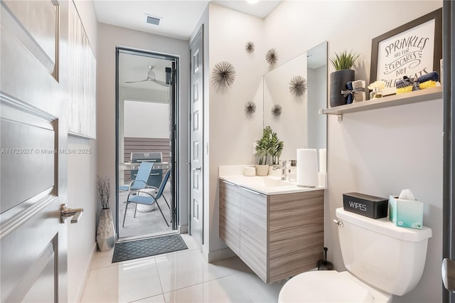 bathroom with toilet, vanity, tile patterned flooring, and visible vents
