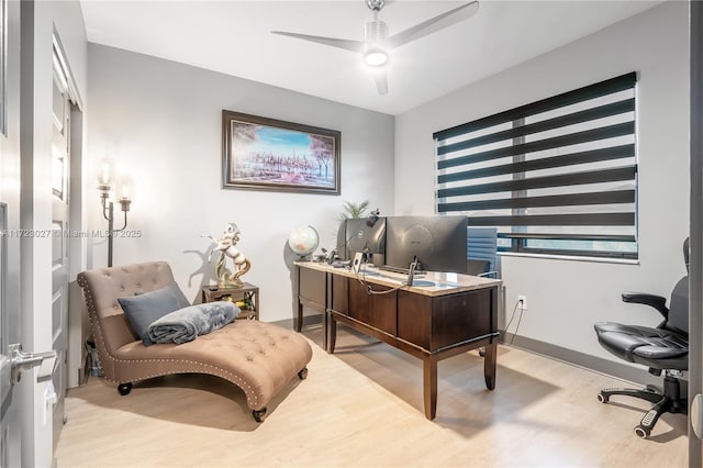 office area featuring baseboards, a ceiling fan, and wood finished floors