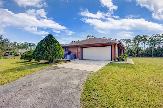 single story home with a front yard, a garage, and central AC