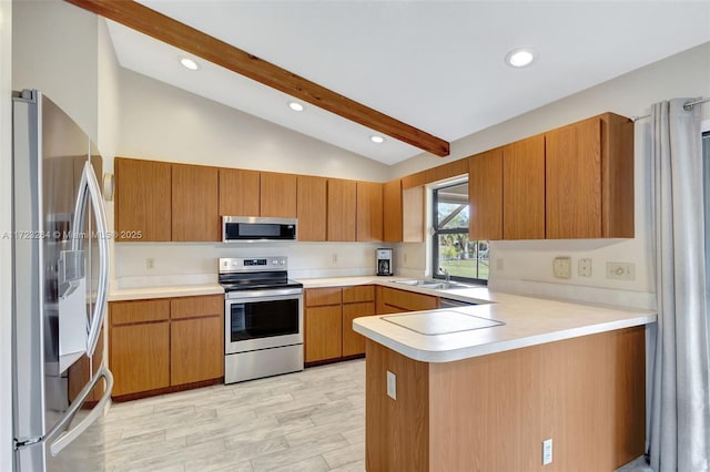 kitchen featuring kitchen peninsula, appliances with stainless steel finishes, lofted ceiling with beams, and sink