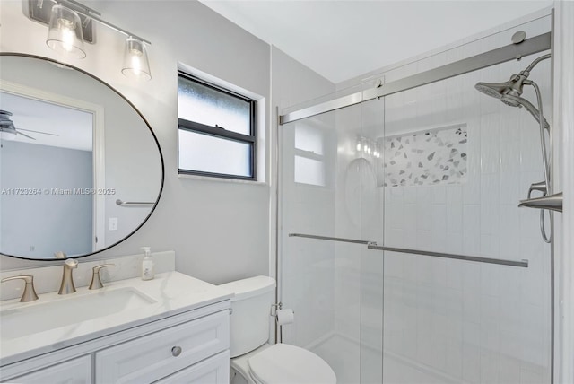 bathroom with toilet, walk in shower, vanity, and ceiling fan