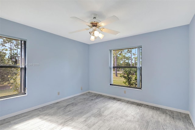 unfurnished room with ceiling fan, plenty of natural light, and light wood-type flooring