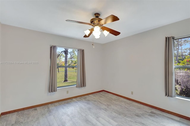 spare room featuring ceiling fan and light hardwood / wood-style flooring