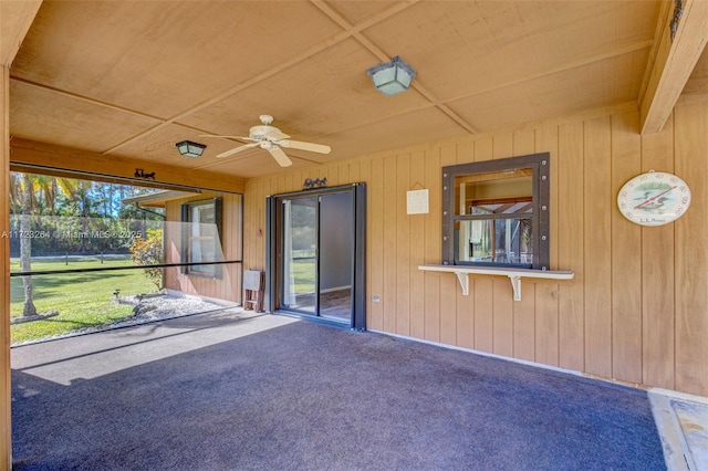 unfurnished sunroom with ceiling fan and wooden ceiling