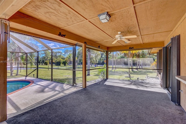 unfurnished sunroom featuring a swimming pool, ceiling fan, and wood ceiling