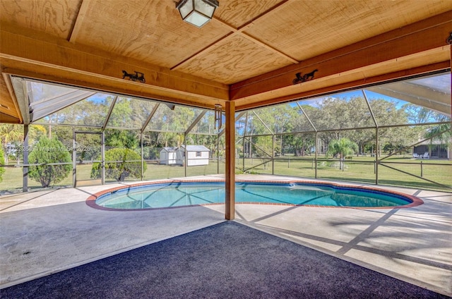 view of pool with a lanai, a patio area, and a yard