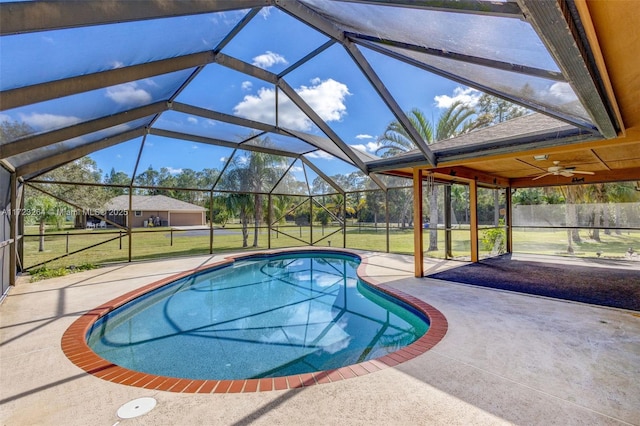 view of swimming pool featuring a lanai, a patio area, and a lawn