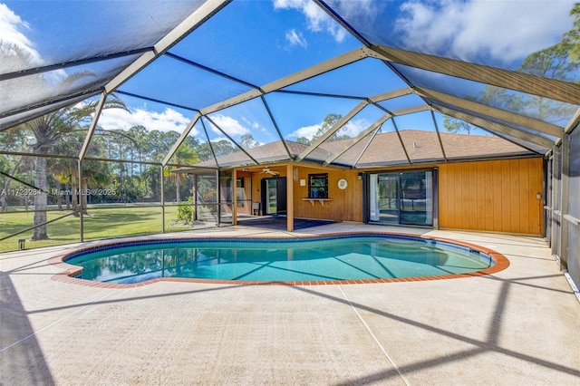 view of pool with a patio and glass enclosure