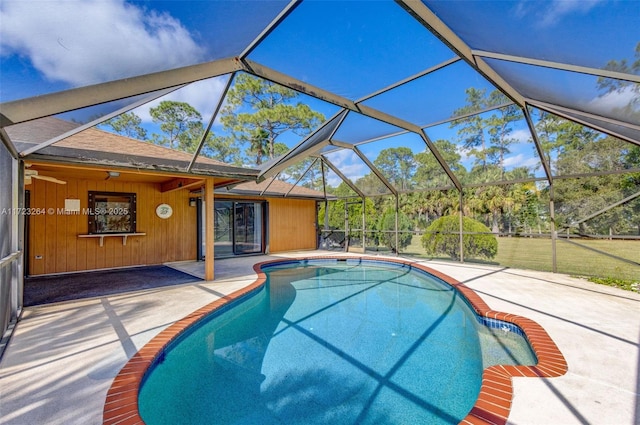 view of pool featuring a lanai, a patio area, and ceiling fan