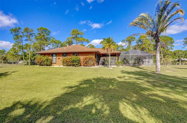 exterior space with a lanai and a yard