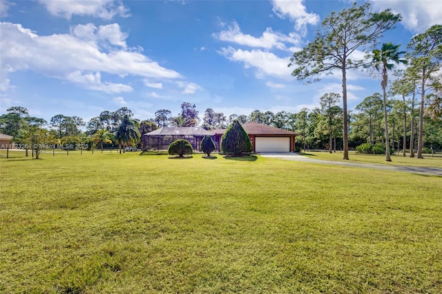 view of front of property with a lanai, a front lawn, and a garage