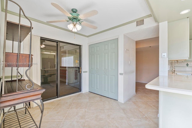 interior space featuring ceiling fan and sink