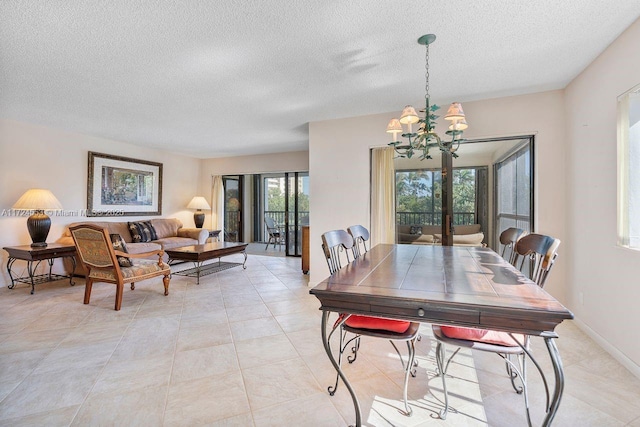 dining room with a textured ceiling, a notable chandelier, and light tile patterned floors