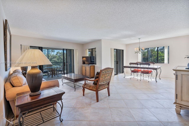 living room featuring a textured ceiling, a chandelier, and light tile patterned floors