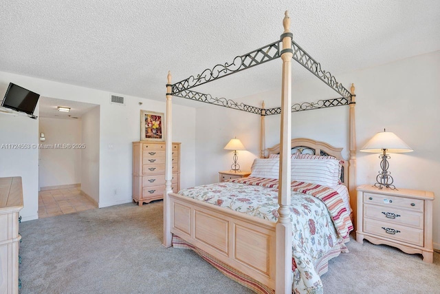 carpeted bedroom with a textured ceiling