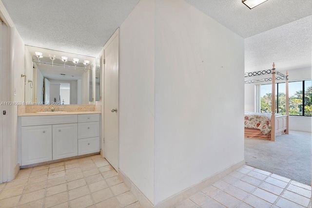 bathroom featuring a textured ceiling and vanity