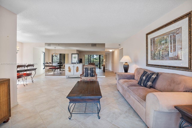 living room with a textured ceiling and light tile patterned floors