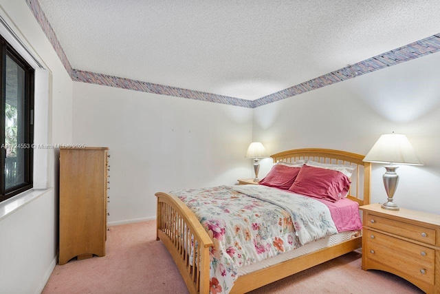 carpeted bedroom featuring a textured ceiling