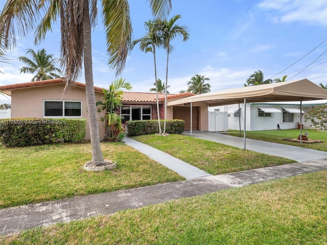 single story home featuring a garage and a front yard